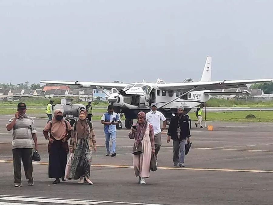 Sejumlah penumpang pesawat perintis berjalan ke terminal penumpang Bandara Trunojoyo Sumenep, Selasa (17/1) siang. Mereka adalah para penumpang pesawat perintis dari Pagerungan, salah satu pulau di Kecamatan Sapeken, Sumenep. (Slamet HD/PortalMadura.Com)